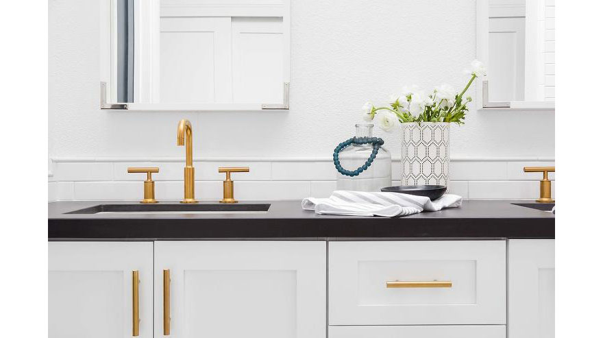 Gold Bathroom Sink Faucet with Black Countertop