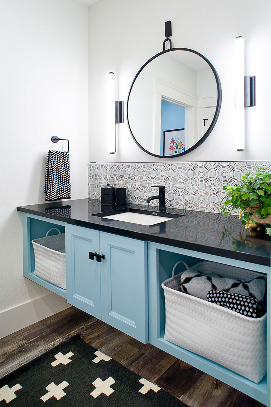 Light Blue Floating Vanity with Black Countertop and Fixtures